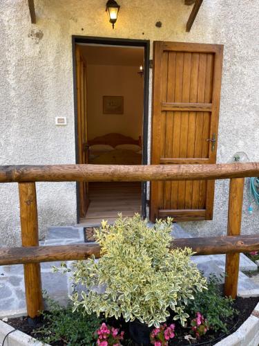 a porch with a wooden fence and a bedroom at Green Riviera Case Vacanza in Borzonasca