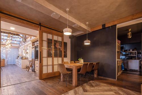 a dining room with a wooden table and chairs at Hotel McLimon in Nový Jičín