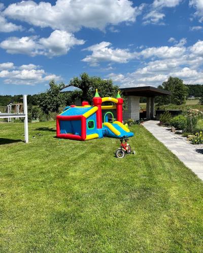 a childs play set in the grass in a yard at Sarnia Polana in Kostrzyca