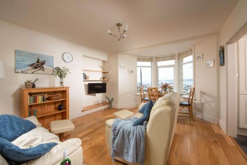 a living room with two couches and a television at Cormorant Views, Marazion in Marazion