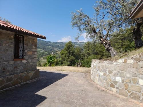a stone walkway next to a stone wall at Villa Aurora in Montegiordano