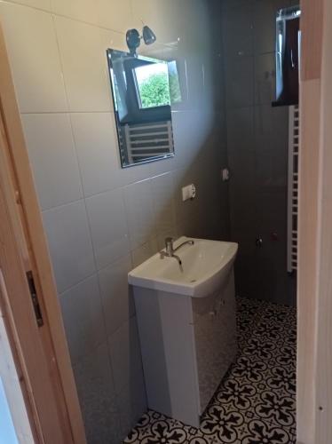 a bathroom with a sink and a mirror at apartamentyDvorskie in Nowy Sącz