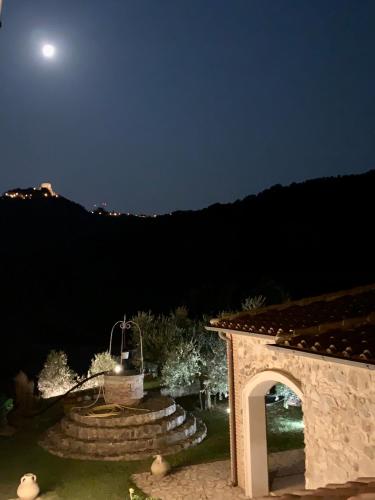a view of a garden at night with a moon at Podere le Mulina in Castiglione dʼOrcia