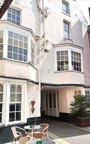 a house with a table and chairs in front of it at The Rose And Crown Hotel in Wisbech