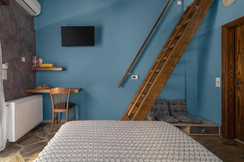 a bedroom with a bed and a blue wall at Agramada in Arnaia