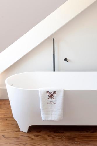 a white bathroom sink with a towel on it at Casa Noronha Lima - Historic Stay in Alvarenga