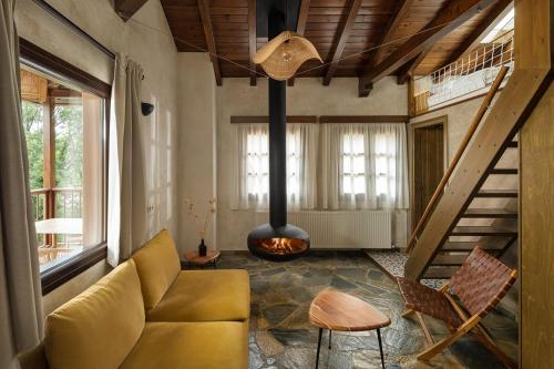 a living room with a couch and a fire place at Agramada in Arnaia