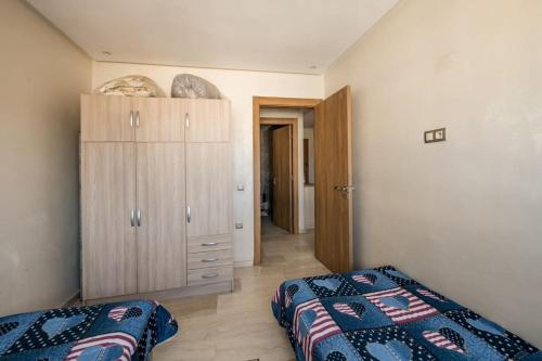 ein Schlafzimmer mit einem Bett und einer Kommode darin in der Unterkunft Champs Elysee in Casablanca