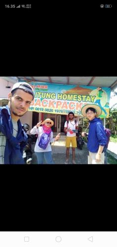 a group of people standing in front of a building at Belitung Backpacker in Tanjungpandan