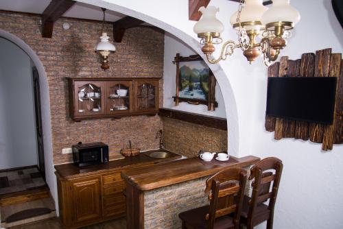 a kitchen with a counter with a sink and a microwave at Апартаменты центр Головная in Chernivtsi