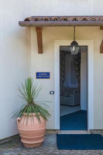 a plant in a pot in front of a door at Casa Bianca Al Mare in Lido di Jesolo