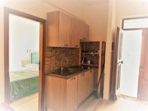 a kitchen with wooden cabinets and a sink at Vivi Conero in Ancona