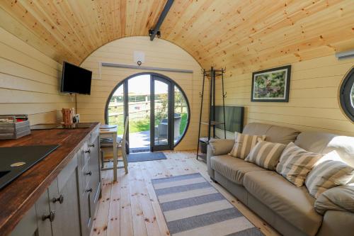 a living room with a couch and a tv at Apple Pod in Arundel