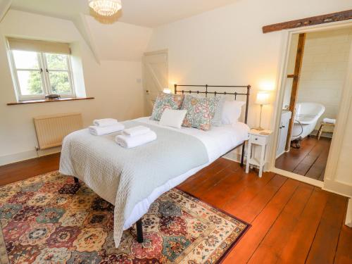 a bedroom with a bed with two towels on it at No 1 Eastington in Cheltenham