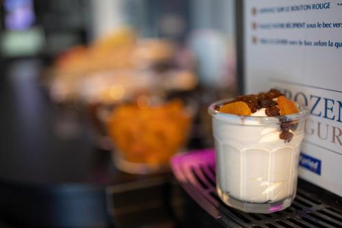 a dessert in a cup with cookies on top of it at Hôtel restaurant Kyriad Fréjus in Fréjus