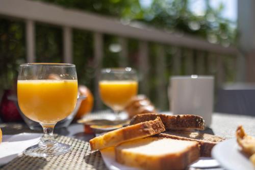 a table with two glasses of orange juice and toast at Hôtel restaurant Kyriad Fréjus in Fréjus