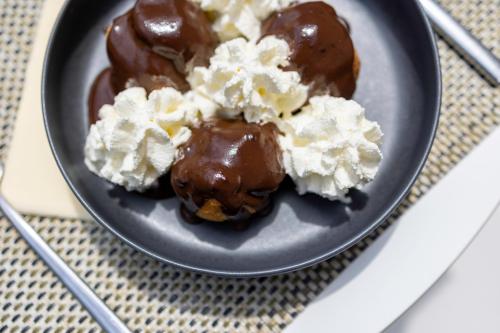 a plate of chocolate and whipped cream on a table at Hôtel restaurant Kyriad Fréjus in Fréjus