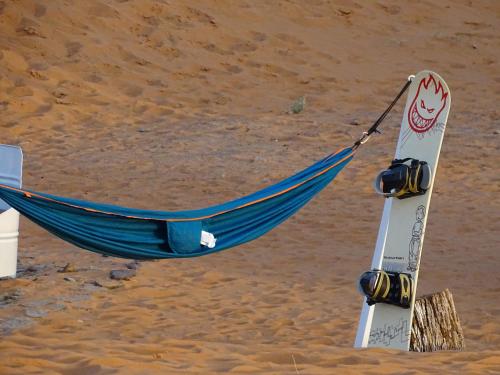 a hammock on the beach with skis in it at Camel Luxury Camp in Merzouga
