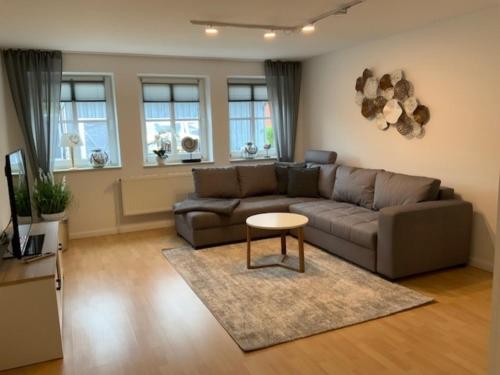 a living room with a couch and a table at Stadtquartier 1 EG in Bredstedt