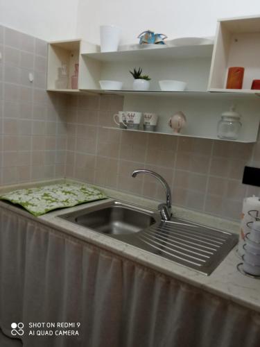 a kitchen with a sink and a counter top at B&B Porta Napoli in Brindisi