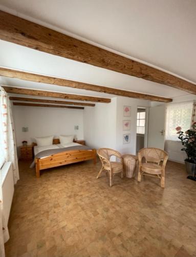 a bedroom with a bed and a table and chairs at Ferienwohnung Keil in Bad Schandau