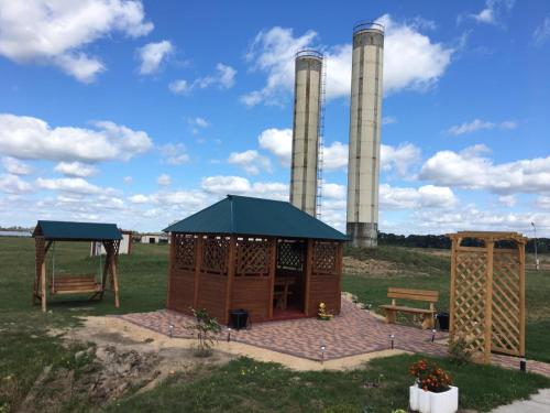 a small wooden building with two smoke stacks at Hotel 7ya in Krasnosilske