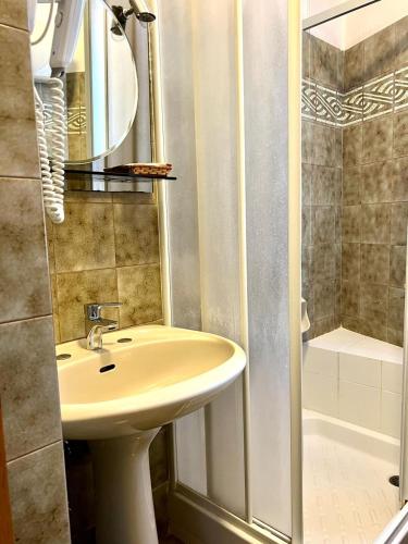 a bathroom with a sink and a shower at Hotel Marvin in Montepulciano