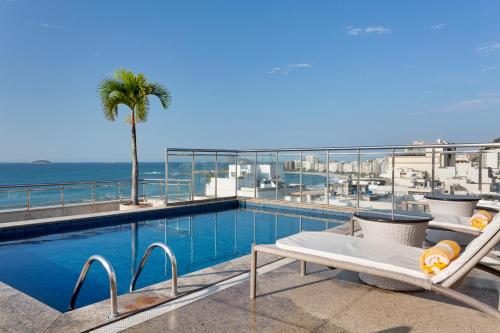 a swimming pool with a view of the ocean at Windsor Palace Copacabana in Rio de Janeiro