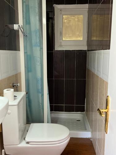 a white toilet sitting next to a bath tub in a bathroom at Hostel can salvado in Cambrils