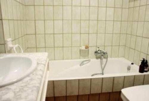 a bathroom with a tub and a sink at Masia Mimosa in Darnius