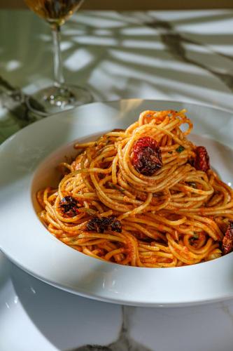 a white bowl filled with pasta on a table at King Solomon Batumi Hotel in Batumi