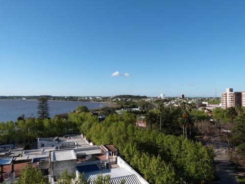 arial view of a city with a body of water at Hotel Royal in Colonia del Sacramento