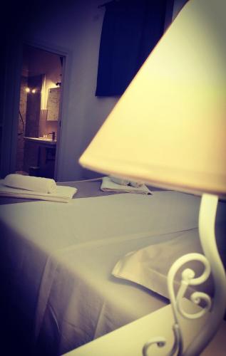a lamp sitting on top of a bed at Dimora d'Estate (Sicilian Holidays) in Milazzo