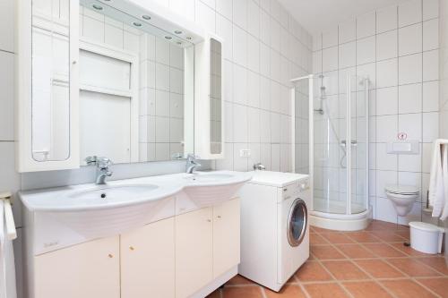 a bathroom with a sink and a washing machine at Casa Melocoton - Private pool - Ocean View - BBQ - Garden - Terrace - Free Wifi - Child & Pet-Friendly - 4 bedrooms - 8 people in La Listada