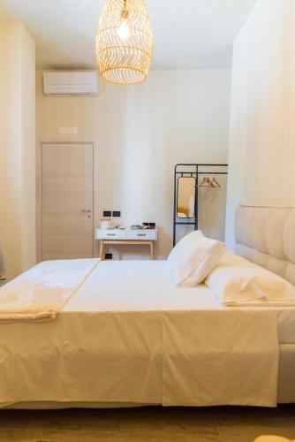 a large bed in a bedroom with a lamp at Tesoro Nascosto B&B in Salerno