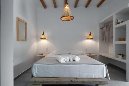 a bedroom with a bed with two towels on it at Xerolithia Guesthouse in Donoussa