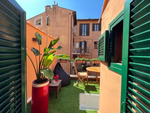 ローマにあるRooftop Boho Loft Spanish Stepsの鉢植えの植物とテーブルのあるパティオ