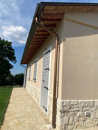 a garage with a door and a stone wall at Agriturismo Pane e Olio in Todi
