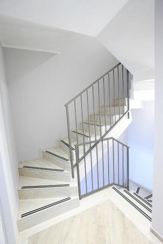 a staircase in a house with white walls and wooden floors at Al Cuore di Valeggio in Valeggio sul Mincio