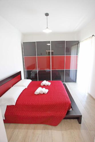 a bedroom with a red bed with towels on it at Al Cuore di Valeggio in Valeggio sul Mincio