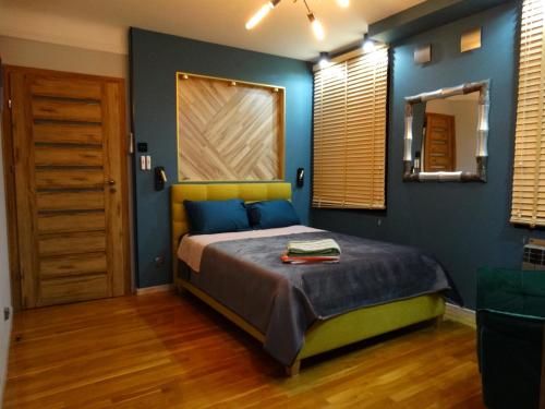 Un pat sau paturi într-o cameră la APPARTEMENTY COCO MANGO