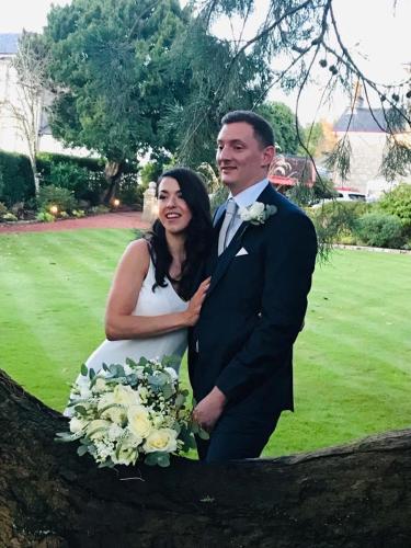 a bride and groom are posing for a picture at Moorlands in Helensburgh