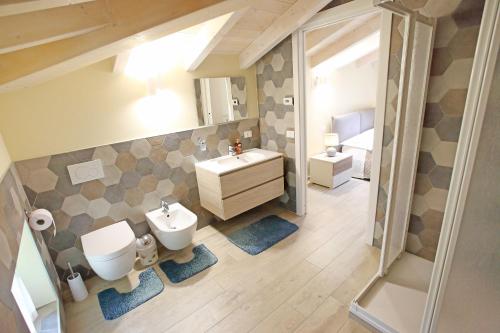 a bathroom with a sink and a toilet and a mirror at Al Cuore di Valeggio in Valeggio sul Mincio