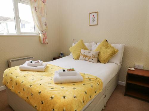 a bedroom with a bed with towels on it at 7 Atlantic Close in Bude