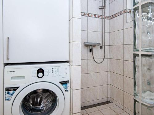 a washing machine in a bathroom with a shower at Seaside Serenity in Vemmingbund-By Traum in Broager