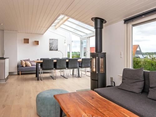 a living room with a stove and a table at Seaside Serenity in Vemmingbund-By Traum in Broager