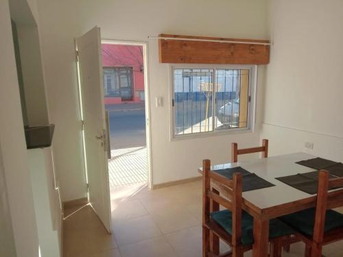 a dining room with a table and a window at CENTENO CASI 9 DE JULIO in Santa Rosa