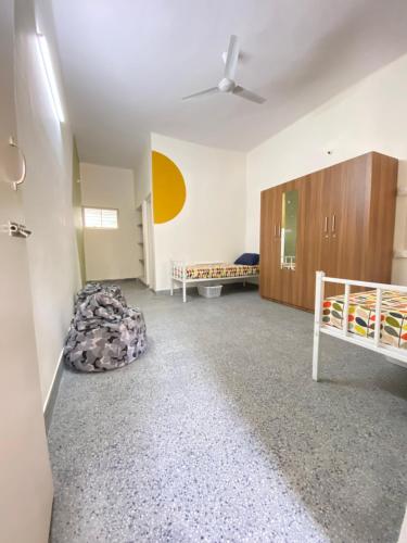 an empty room with two bunk beds and a ceiling at Habitat15@airlines in Bengaluru