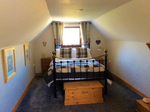 a bedroom with a bunk bed with a window at Bosvean Cottage in Bude