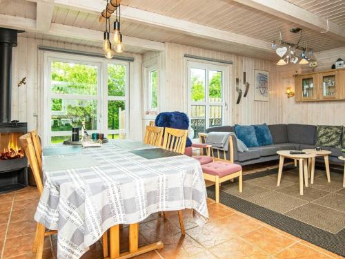 a living room with a table and a couch at 5 person holiday home in Hemmet in Hemmet